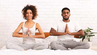 a man and a woman practice meditation