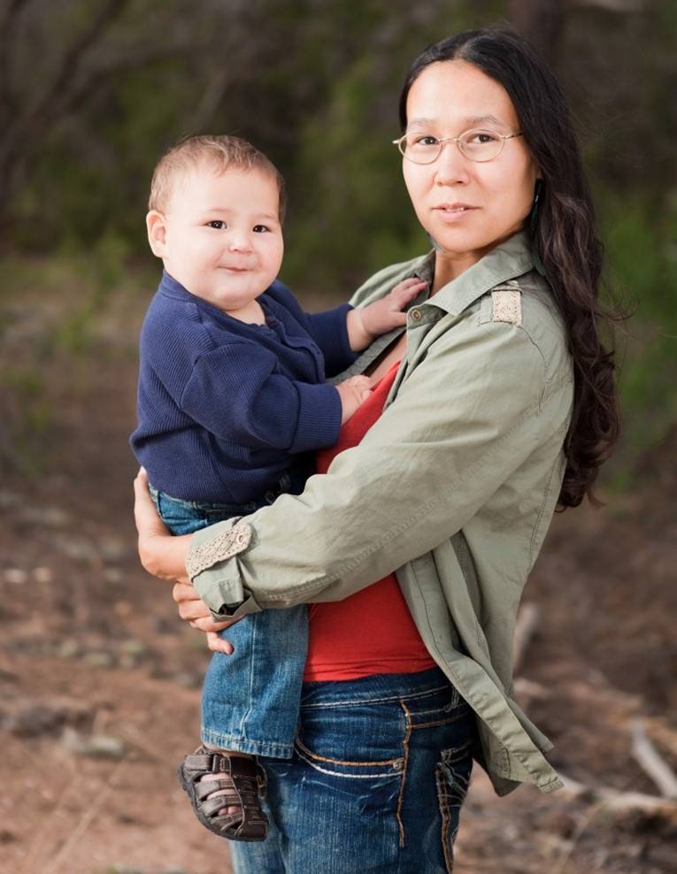 Native woman holding son